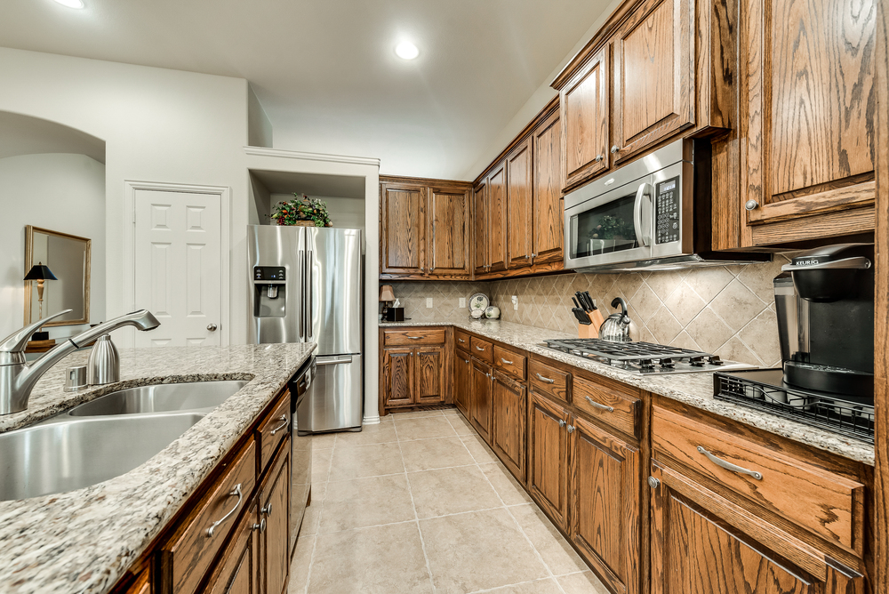    Gourmet Kitchen features Granite Countertops and Stainless Steel Appliances 