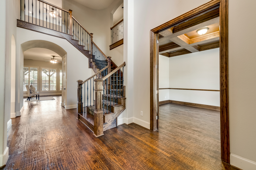    Soaring Ceilings with Hand Scraped Hardwood Floors throughout Main Living Areas 
