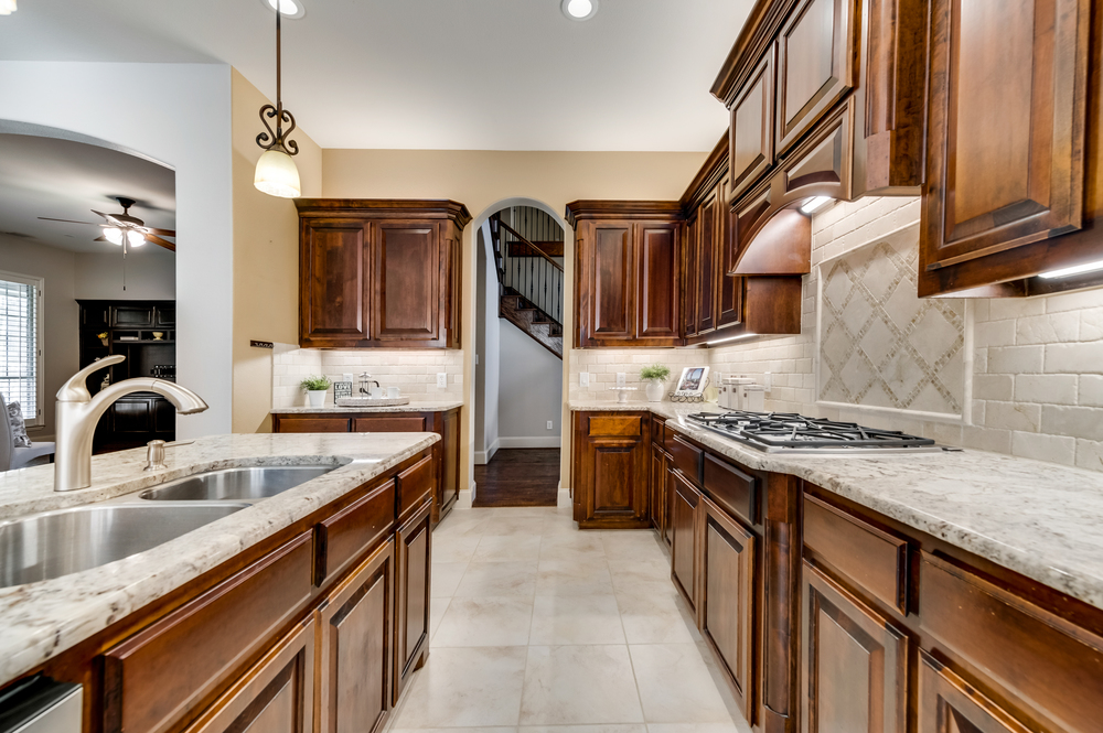    Gourmet Kitchen features White Granite and Abundance of Built In Cabinetry 